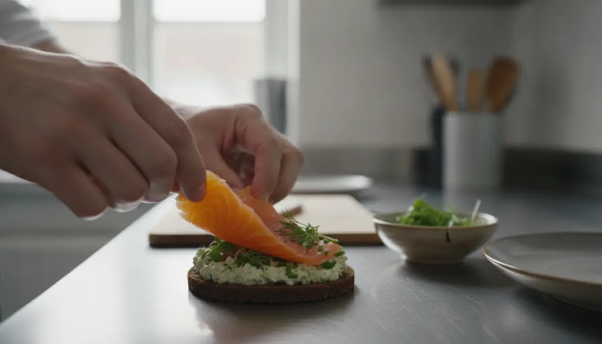 Preparing authentic Danish smushi with salmon and herb spread on rye bread